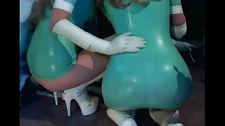 Nurse troika in latex underclothing and gloves